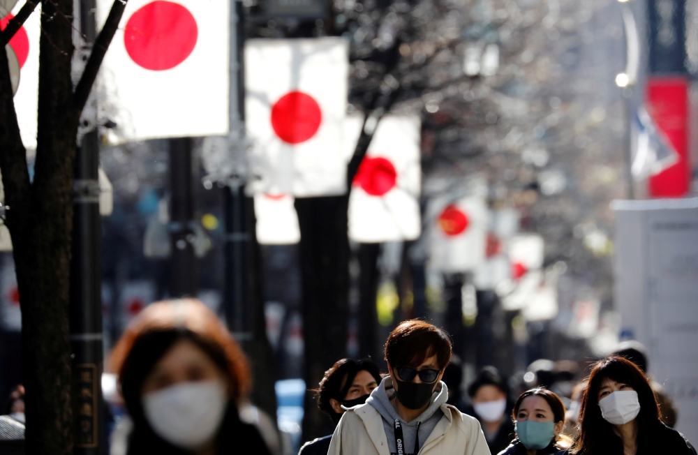 Pedestrians wearing protective masks, amid the coronavirus disease (COVID-19) outbreak, make their way at Ginza shopping district which closed to cars on Sunday in Tokyo, Japan, January 10, 2021. REUTERS/Kim Kyung-Hoon