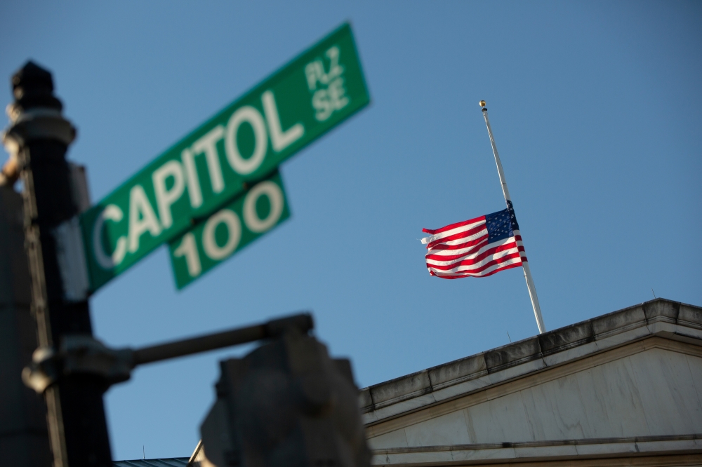 A flag flies at half-mast at the Longworth House Office Building across from the US Capitol building on Capitol Hill in Washington, US, January 10, 2021. Reuters/Allison Shelley