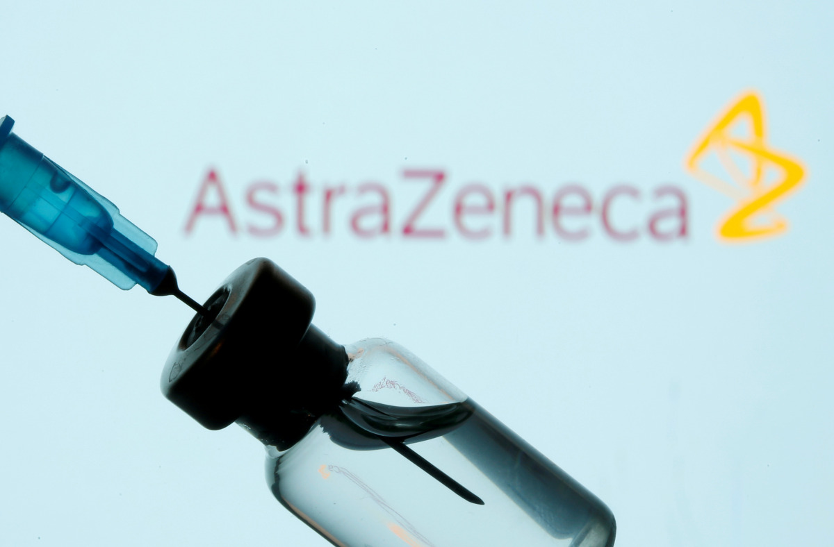 FILE PHOTO: A vial and sryinge are seen in front of a displayed AstraZeneca logo in this illustration taken January 11, 2021. REUTERS/Dado Ruvic/Illustration/File Photo
