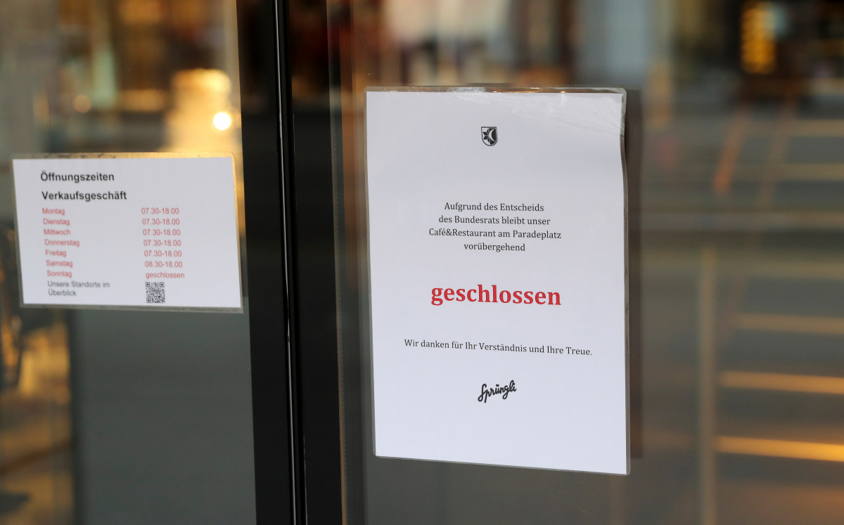 A note explaining the temporary closure by authorities due to COVID-19 measures is placed on the door of the Confiserie Spruengli restaurant, as the spread of the coronavirus disease continues, in Zurich, Switzerland January 11, 2021. REUTERS/Arnd Wiegman