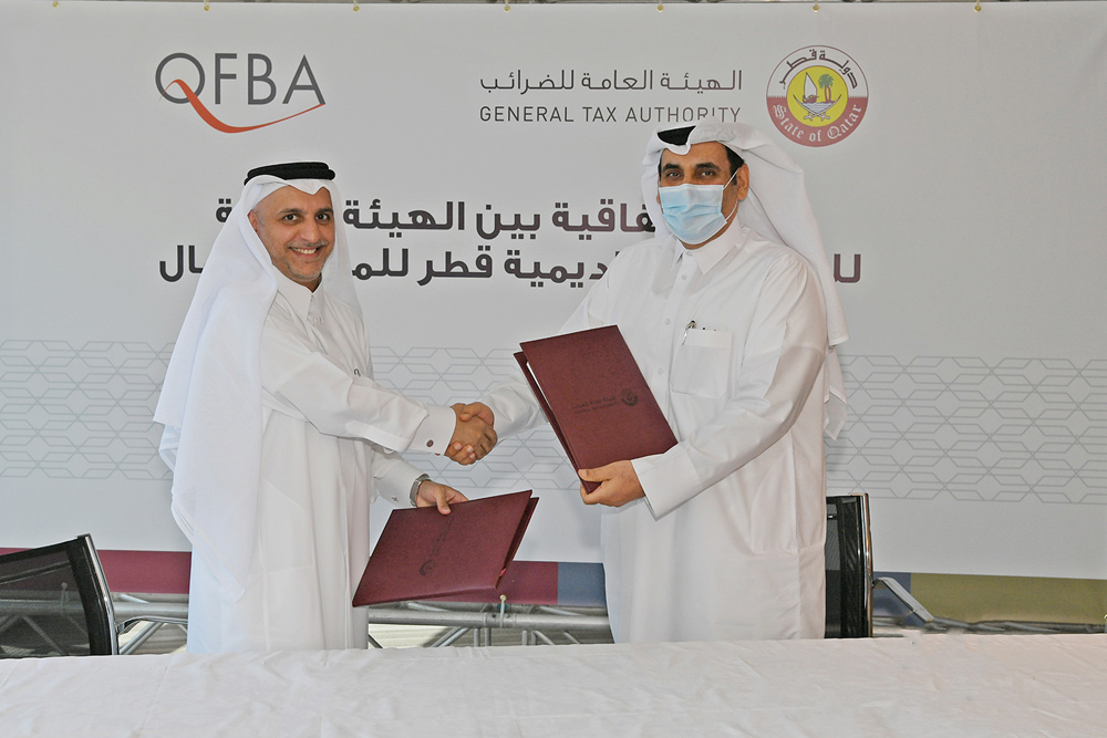 President of General Tax Authority, Ahmed bin Issa Al Mohannadi (right), and Chief Executive Officer of Qatar Finance and Business Academy, Dr. Khalid Mohammed Al Horr, during the signing ceremony in Doha recently. 