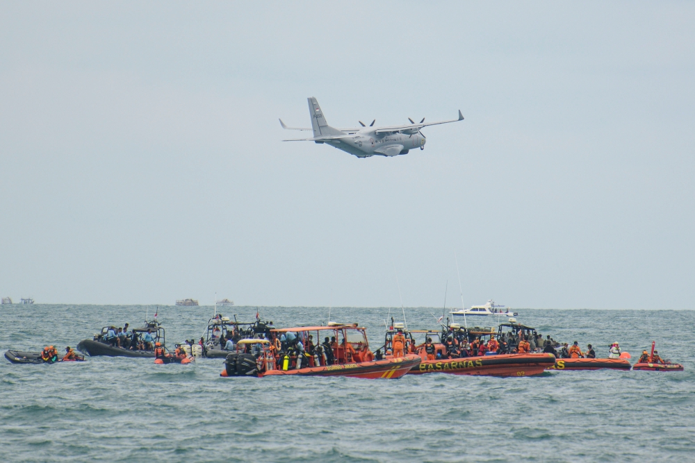 An Indonesian Military aircraft CN-235 is seen during the search and rescue operation for the Sriwijaya Air flight SJ 182, at the sea off the Jakarta coast, Indonesia, January 14, 2021 in this photo taken by Antara Foto. Antara Foto/M Risyal Hidayat/ via 