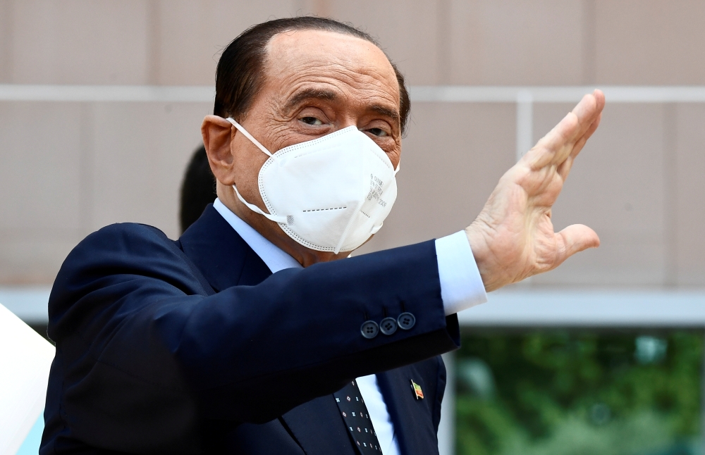 Former Italian Prime Minister Silvio Berlusconi gestures as he is discharged from Milan's San Raffaele hospital, where he was being treated after testing positive for the coronavirus disease (COVID-19) and diagnosed with mild pneumonia, in Milan, Italy, S