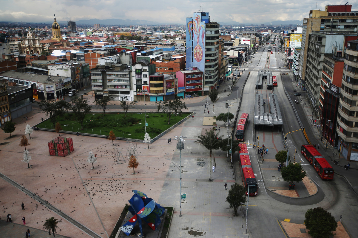People and Transmilenio system buses are seen in the commercial area of San Victorino during the mandatory total isolation decreed by the mayor's office, amidst an outbreak of the coronavirus disease (COVID-19), in Bogota, Colombia January 8, 2021. REUTER