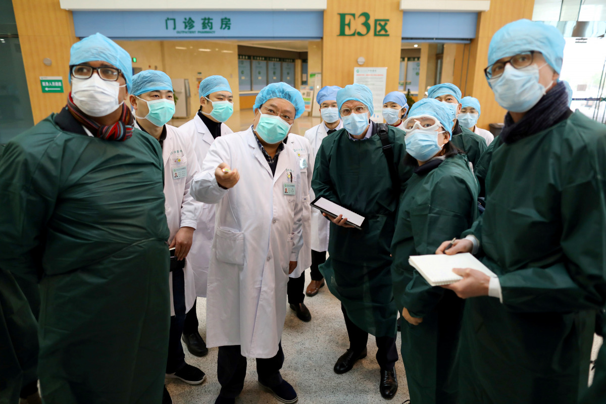 FILE PHOTO: Experts from China and the World Health Organization (WHO) joint team wearing face masks visit Wuhan Tongji Hospital in Wuhan, the epicentre of the novel coronavirus outbreak, in Hubei province, China February 23, 2020. China Daily via REUTERS