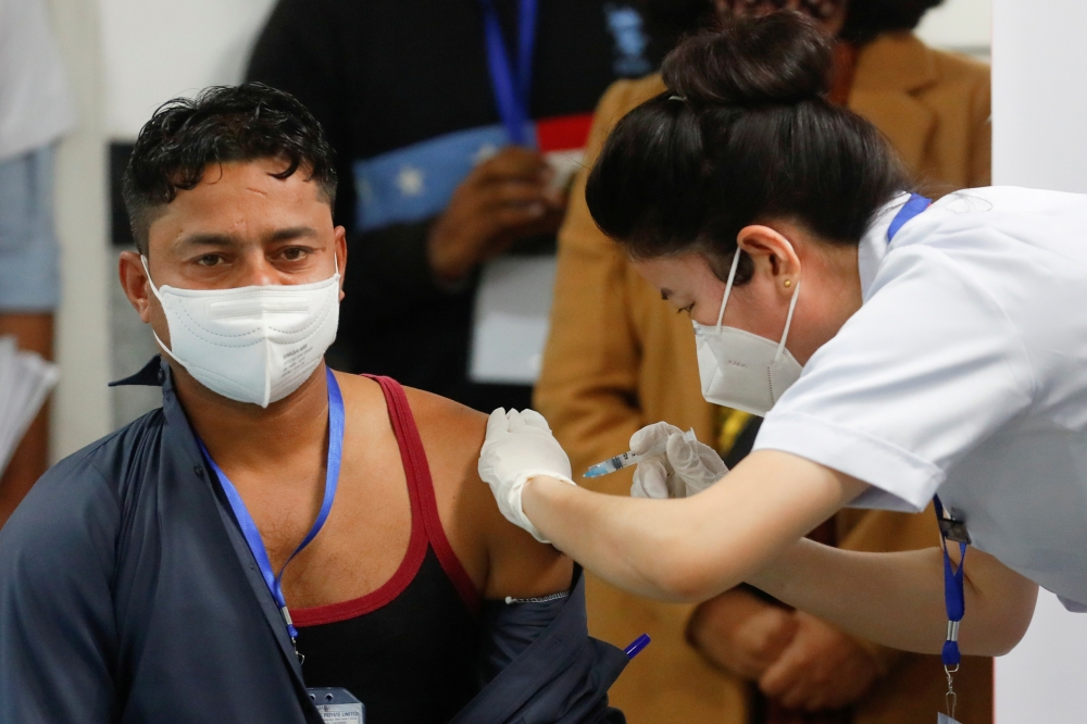Sanitation worker Manish Kumar, who according to the officials is the first person in the country vaccinated against the Covid-19, receives a dose of Bharat Biotech's COVAXIN. Reuters/Adnan Abidi