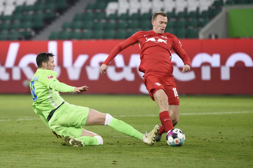 RB Leipzig's Lukas Klostermann in action with VfL Wolfsburg's Wout Weghorst Pool via REUTERS/Fabian Bimmer DFL regulations prohibit any use of photographs as image sequences and/or quasi-video.