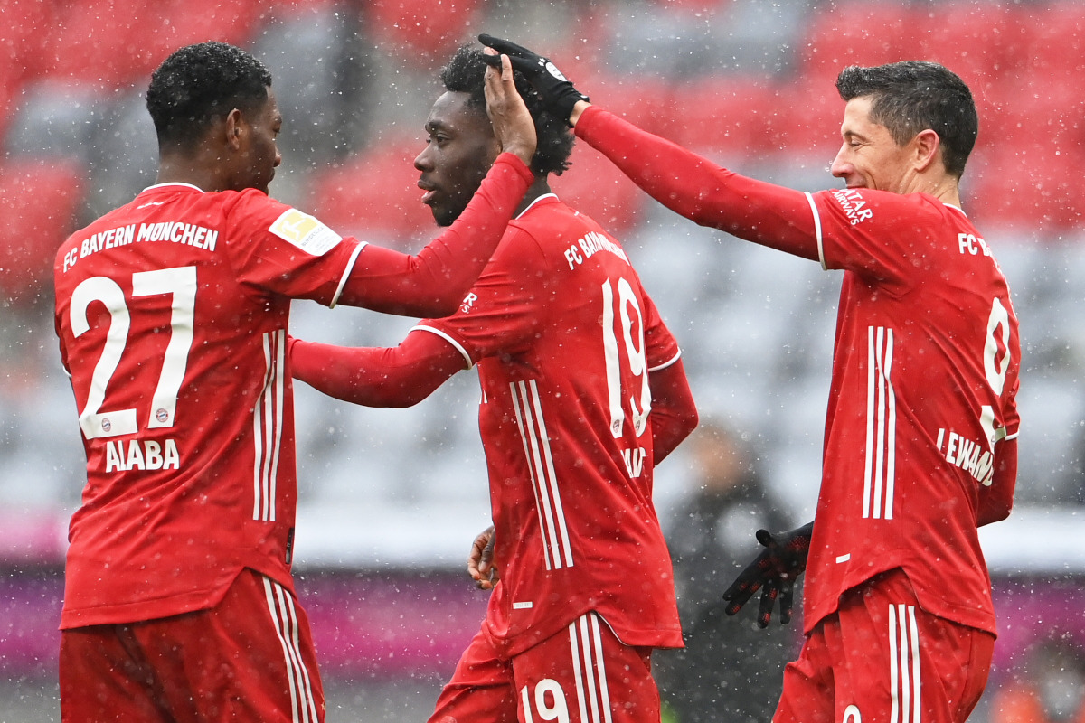 Soccer Football - Bundesliga - Bayern Munich v SC Freiburg - Allianz Arena, Munich, Germany - January 17, 2021 Bayern Munich's Robert Lewandowski celebrates scoring their first goal with Alphonso Davies and David Alaba Pool via REUTERS/Christof Stache DFL