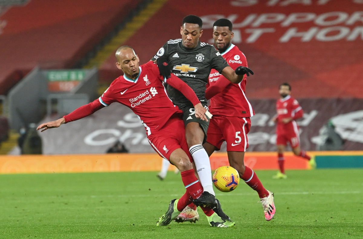 Soccer Football - Premier League - Liverpool v Manchester United - Anfield, Liverpool, Britain - January 17, 2021 Manchester United's Anthony Martial in action with Liverpool's Fabinho and Georginio Wijnaldum Pool via REUTERS/Paul Ellis 