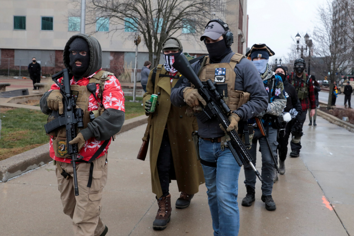 Members of the Boogaloo Bois protest against the election of President-elect Joe Biden, outside the Michigan State Capitol in Lansing, Michigan, U.S. January 17, 2021. REUTERS/Rebecca Cook 
