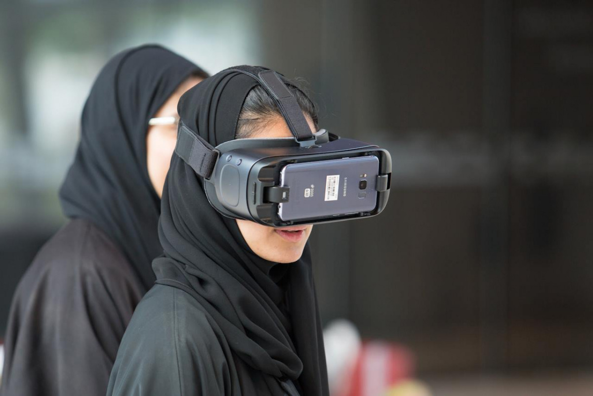A Northwestern Qatar student using VR glasses.