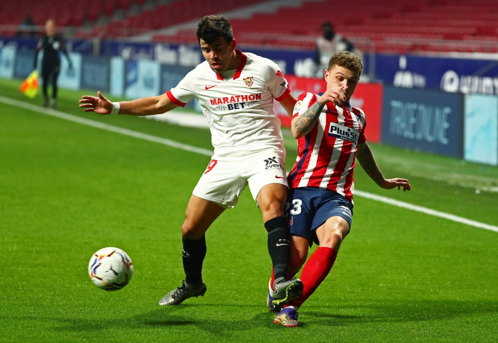 Sevilla's Marcos Acuna in action with Atletico Madrid's Kieran Trippier REUTERS/Sergio Perez