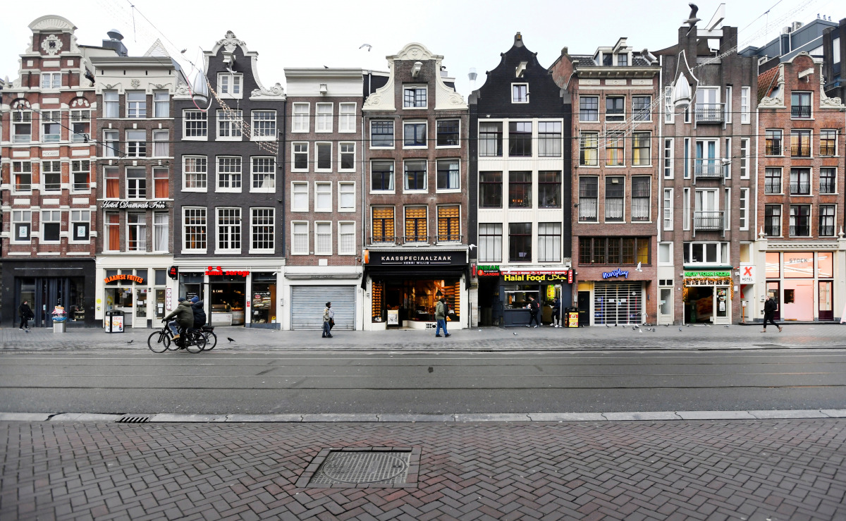 FILE PHOTO: People walk on an empty street as Netherlands has gone into lockdown as the spread of the coronavirus disease (COVID-19) continues in Amsterdam, Netherlands December 15 2020, REUTERS/Piroschka van de Wouw/File Photo
