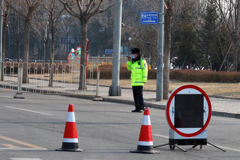 Police guard a blocked-off street in a residential neighbourhood following new cases of the coronavirus disease (COVID-19) in Tiangongyuan area of Daxing district in Beijing, China, January 20, 2021. REUTERS/Thomas Peter