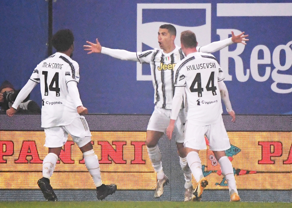 Juventus' Cristiano Ronaldo celebrates scoring their first goal with Weston McKennie and Dejan Kulusevski REUTERS/Alberto Lingria
