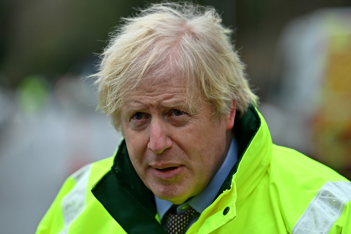 Britain's Prime Minister Boris Johnson talks to members of the media after being shown the Environment Agency's flood defence preparations during his visit to Withington in Manchester, as Storm Christoph brings heavy rains and flooding across the country,