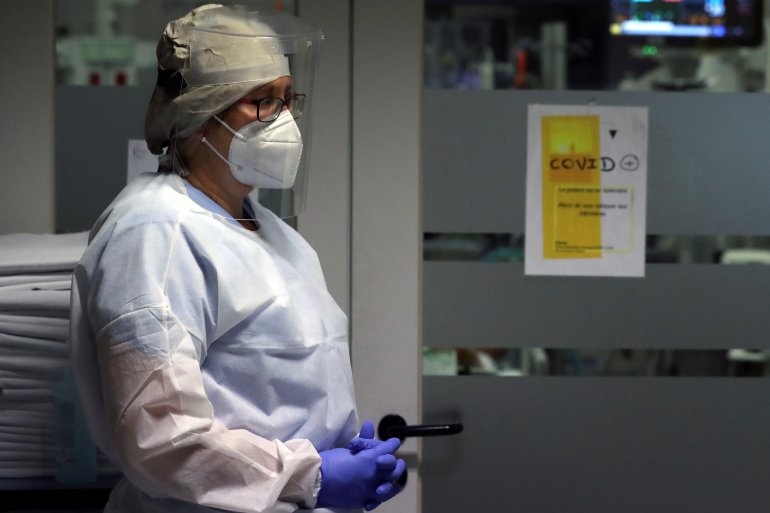 A member of the medical personnel wearing a protective suit, protective mask and face shield is seen in the intensive care unit at the CHIREC Braine l?Alleud-Waterloo hospital, in Braine l'Alleud, Belgium, October 23, 2020
