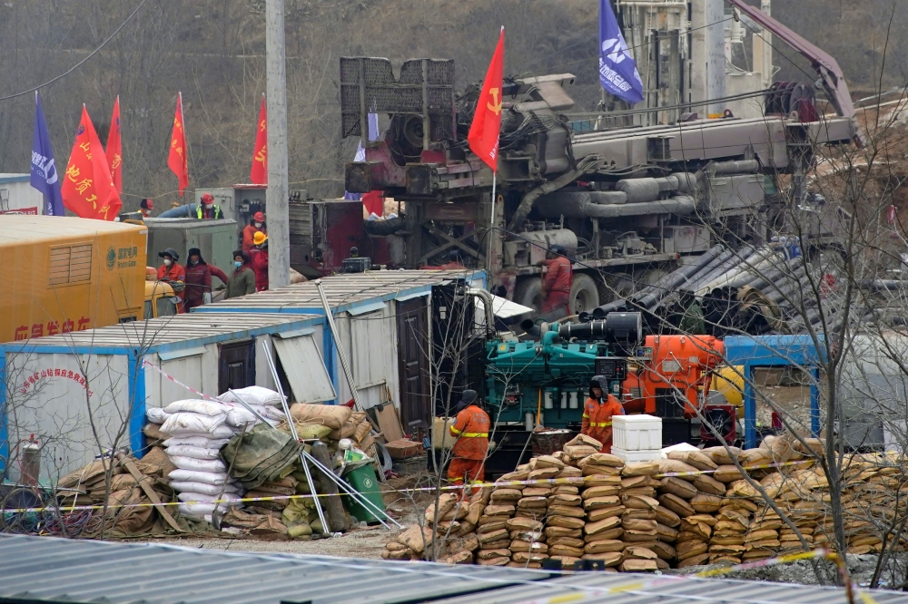 Rescuers work at the Hushan gold mine where workers were trapped underground after the Jauary 10 explosion, in Qixia, Shandong province, China January 22, 2021. Reuters/Aly Song