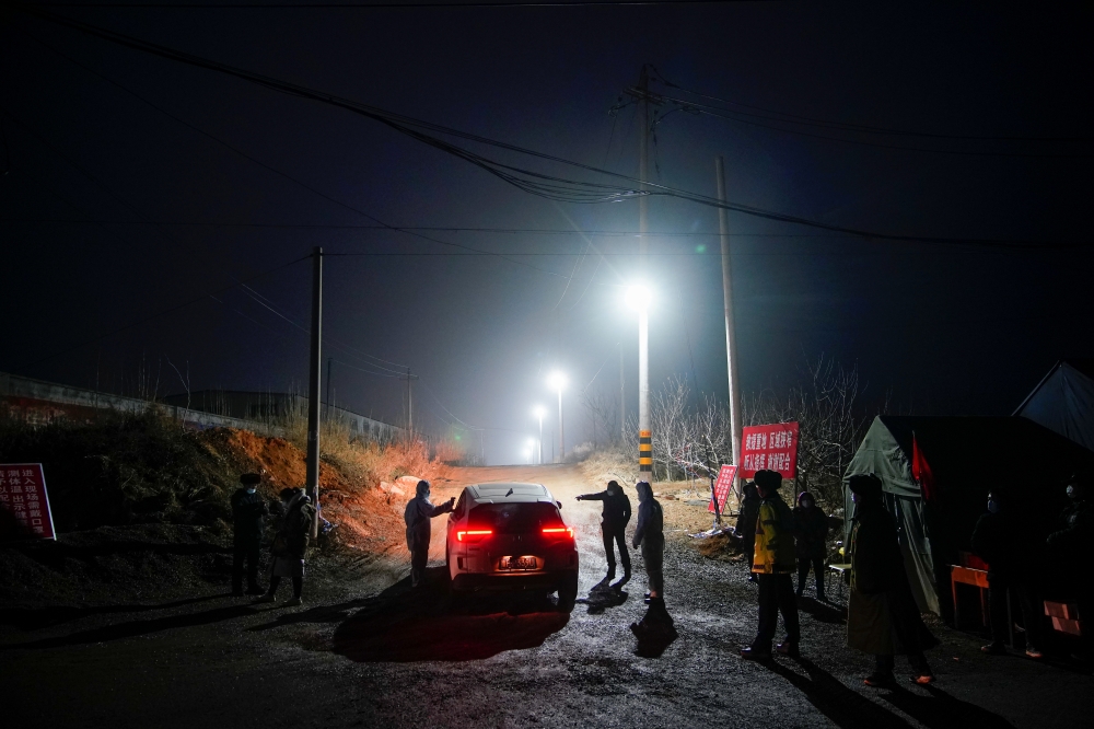 Security members keep watch at an entrance to the Hushan gold mine, where workers are trapped underground after the January 10 explosion, in Qixia, Shandong province, China January 21, 2021. Reuters/Aly Song