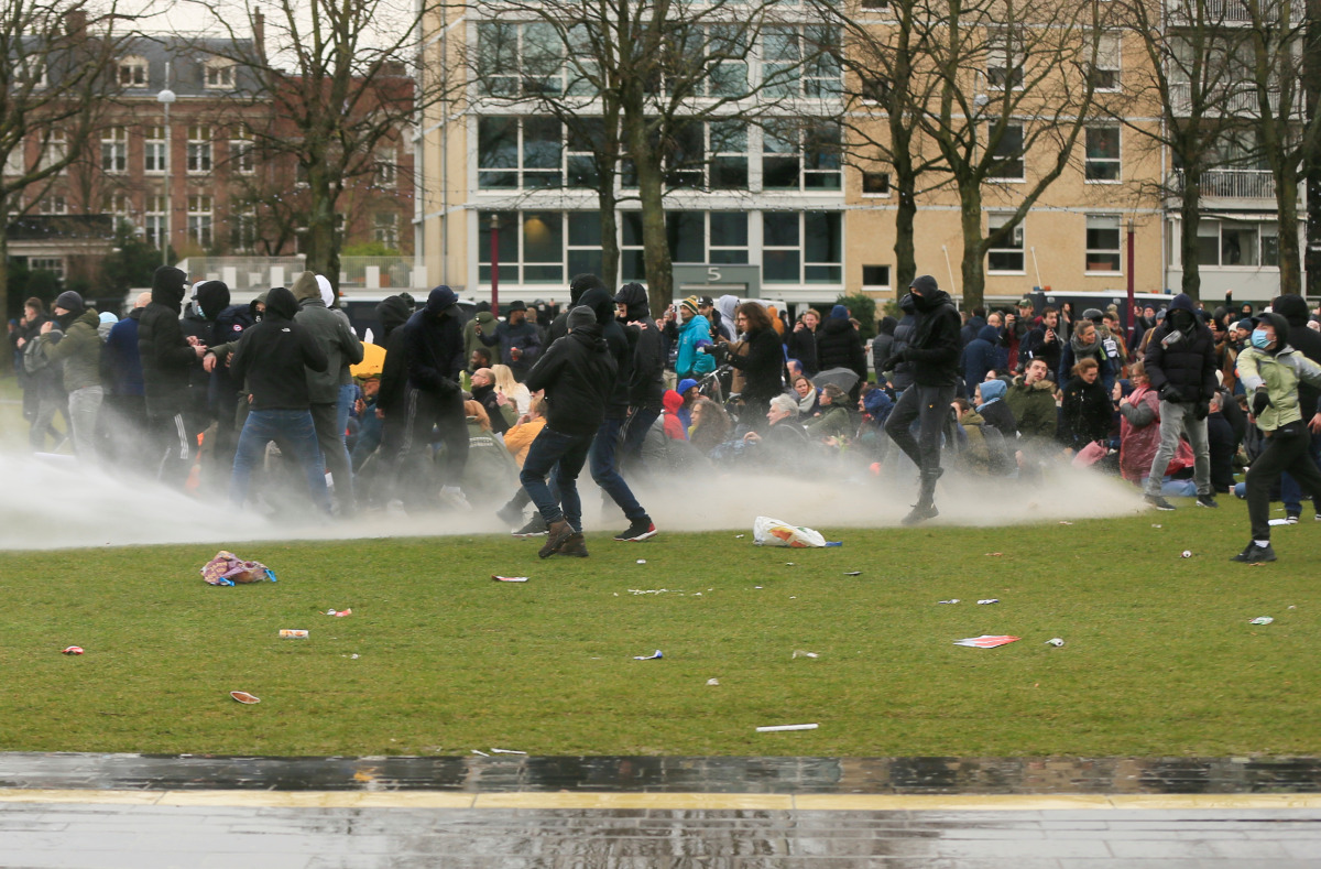 Police uses a water canon during a protest against restrictions put in place to curb the spread of the coronavirus disease (COVID-19), in Amsterdam, Netherlands January 24, 2021. REUTERS/Eva Plevier
