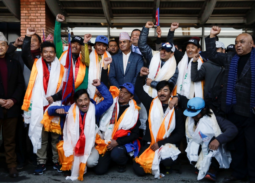 Nepali climbers who were the first to scale K2, the world's second tallest peak, in winter, cheer upon their arrival from the mountain, at Tribhuvan International Airport in Kathmandu, Nepal January 26, 2021. REUTERS/Navesh Chitrakar