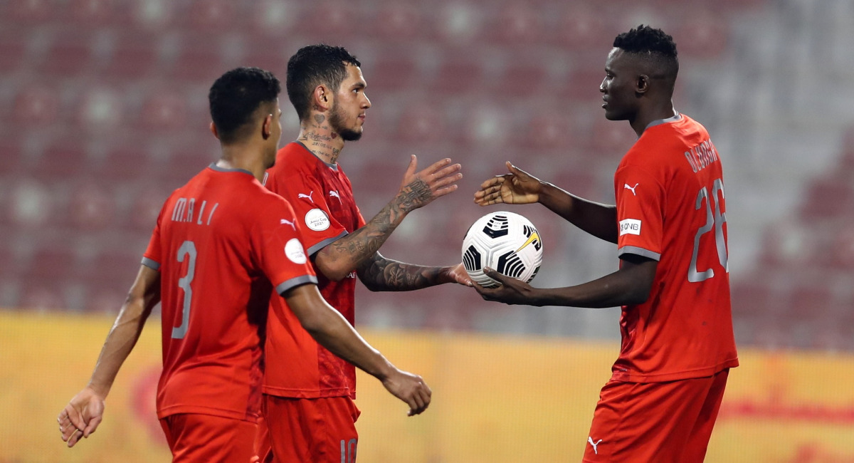 Michael Olunga (right) with team-mates after the end of Amir Cup match against Al Ahli on Monday. 