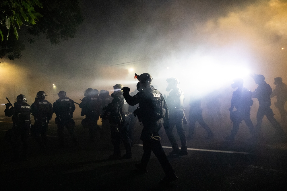Portland Police officers disperse a crowd of protesters using CS gas and less lethal munitions on the 100th consecutive night of protests in Portland, Oregon, U.S. September 5, 2020. Picture taken September 5, 2020. Reuters/Caitlin Ochs