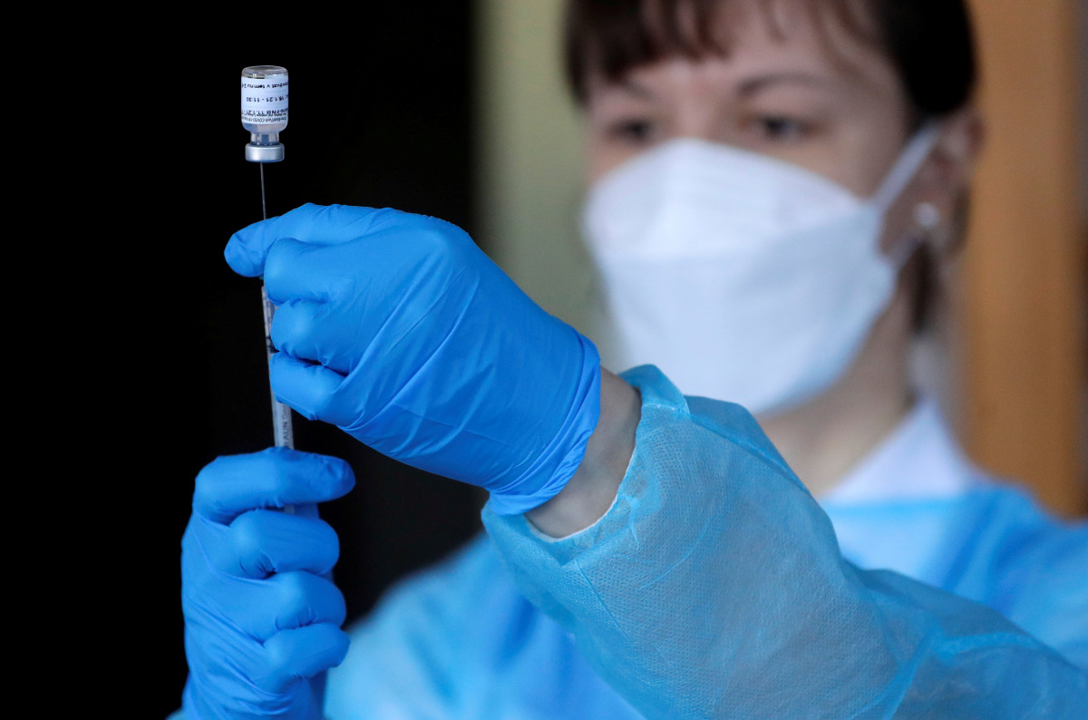 FILE PHOTO: A member of a mobile vaccination team prepares a shot of the coronavirus disease (COVID-19) vaccine at the Home of Holy Family, for people with mental disabilities of welfare organisation Caritas, in Prague, Czech Republic, January 13, 2021. R