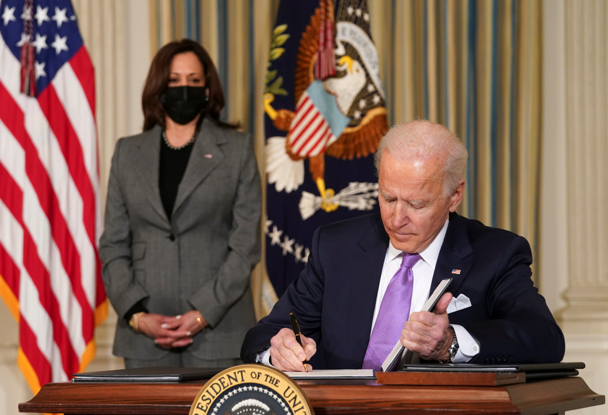 U.S. Vice President Kamala Harris watches as President Joe Biden signs executive orders on his racial equity agenda at the White House in Washington, U.S., January 26, 2021. REUTERS/Kevin Lamarque
