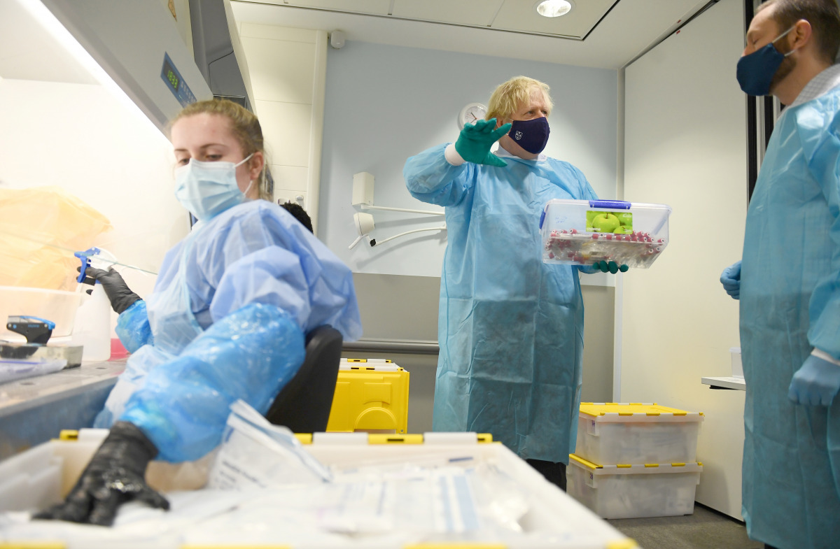 British Prime Minister Boris Johnson is shown the Lighthouse Laboratory used for processing PCR samples, during a visit to the Queen Elizabeth University Hospital campus in Glasgow, Scotland, Britain January 28, 2021. Jeff J Mitchell/Pool via REUTERS
