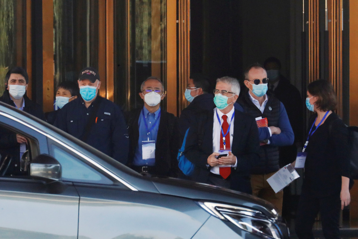 Members of the World Health Organisation (WHO) team tasked with investigating the origins of the coronavirus disease (COVID-19) prepare to leave a hotel in Wuhan, Hubei province, China January 29, 2021. REUTERS/Thomas Peter
