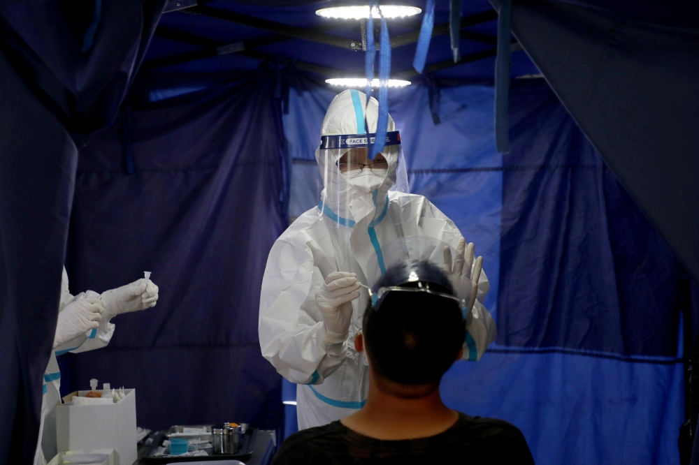 A doctor collects a swab sample from a man at a testing station of Clinic 365, amid the coronavirus disease (COVID-19) outbreak in Kuala Lumpur, Malaysia January 29, 2021. REUTERS/Lim Huey Teng
