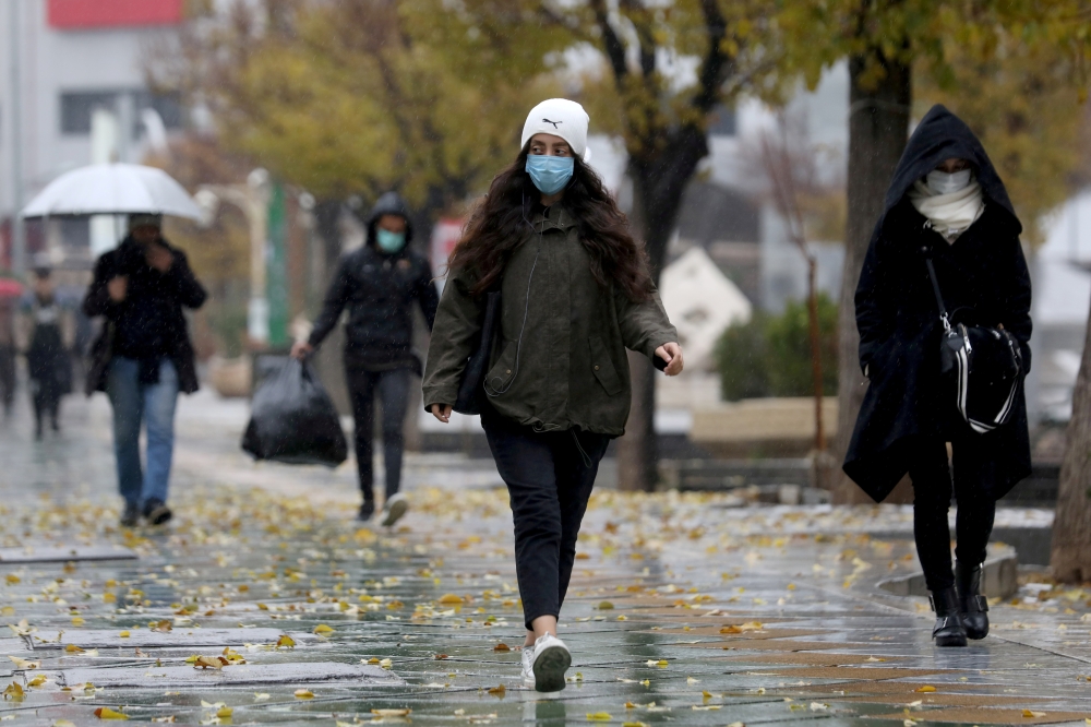 People walk on a street after Tehran reopened following a two-week shutdown, amid the coronavirus disease (COVID-19), Iran December 6, 2020. Majid Asgaripour/WANA (West Asia News Agency) via Reuters 