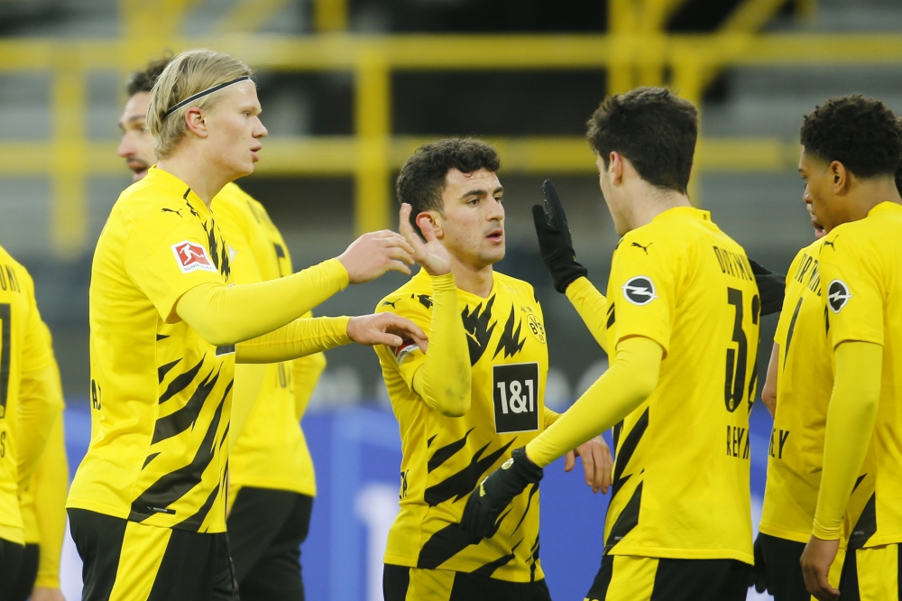 Borussia Dortmund's Erling Braut Haaland and teammates celebrate after FC Augsburg's Felix Uduokhai scored Borussia Dortmund 's third with an own goal Pool via REUTERS/Leon Kuegeler 