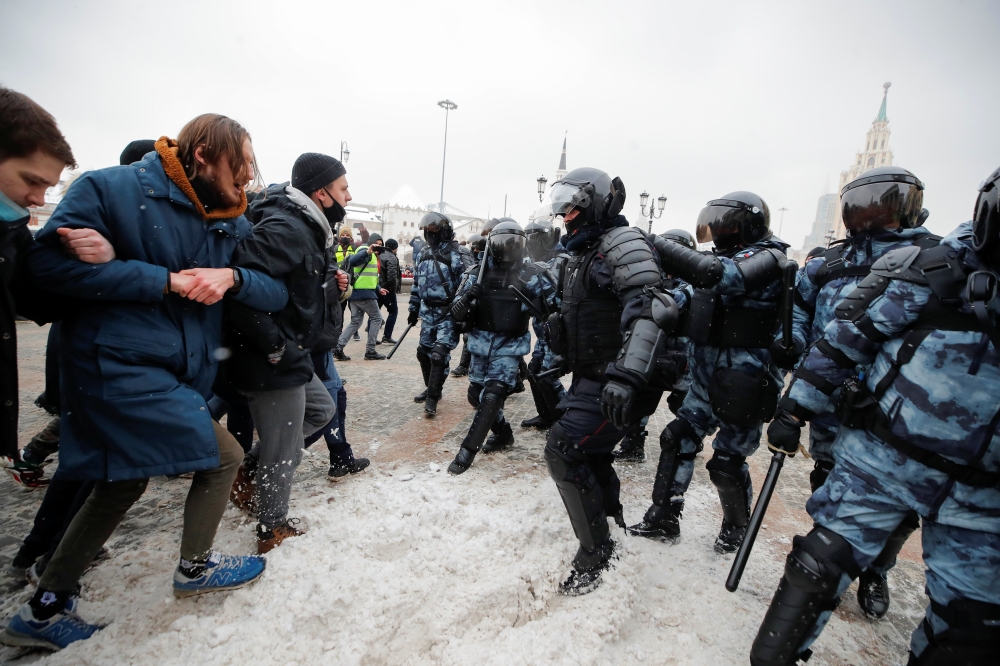People are seen in front of law enforcement officers during a rally in support of jailed Russian opposition leader Alexei Navalny in Moscow, Russia January 31, 2021. REUTERS/Maxim Shemetov