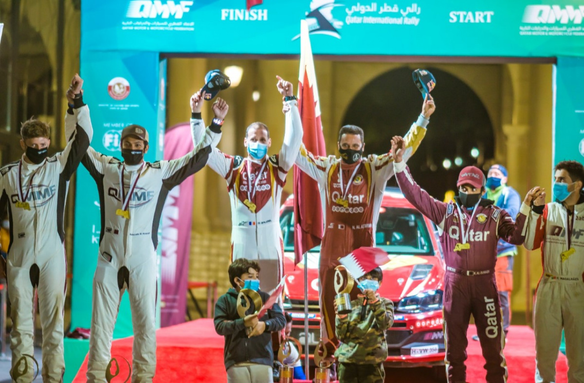 The podium winners of the Qatar International Rally, Nasser Saleh Al Attiyah, Matthieu Baumel; Abdulaziz Al Kuwari, James Fulton and Khalid Al Suwaidi and Hugo Magalhães celebrate on the podium.