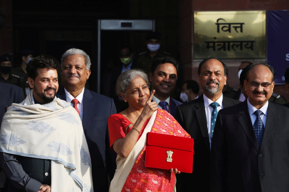 India's Finance Minister Nirmala Sitharaman stands next to Minister of State for Finance and Corporate Affairs Anurag Thakur (L) as she leaves her office to present the federal budget in the parliament in New Delhi, India, February 1, 2021. Reuters/Anushr