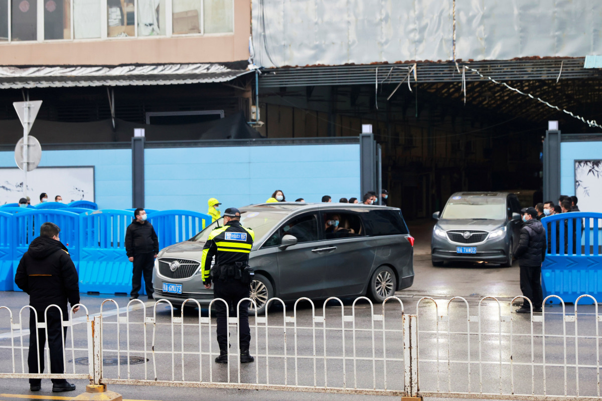 Cars carrying members of the World Health Organization (WHO) team tasked with investigating the origins of the coronavirus disease (COVID-19) leave Huanan seafood market in Wuhan, Hubei province, China January 31, 2021. REUTERS/Thomas Peter
