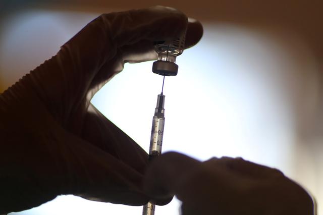 FILE PHOTO: A healthcare worker draws the coronavirus disease (COVID-19) vaccine from a vial at Mission Commons assisted living community in Redlands, California, U.S., January 15, 2021. REUTERS/Lucy Nicholson
