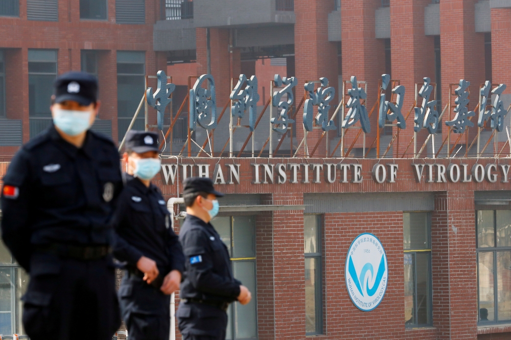 Security personnel keep watch outside the Wuhan Institute of Virology during the visit by the World Health Organization (WHO) team tasked with investigating the origins of the coronavirus disease (COVID-19), in Wuhan, Hubei province, China February 3, 202