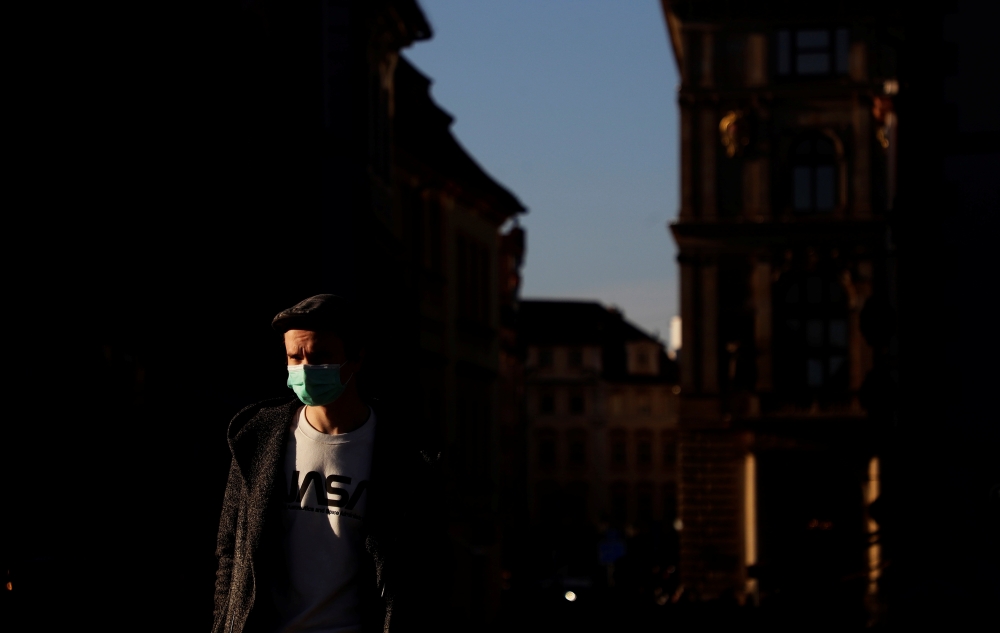 A man wearing a face mask walks on a street amid the coronavirus disease (COVID-19) outbreak in Prague, Czech Republic, January 31, 2021. REUTERS/David W Cerny