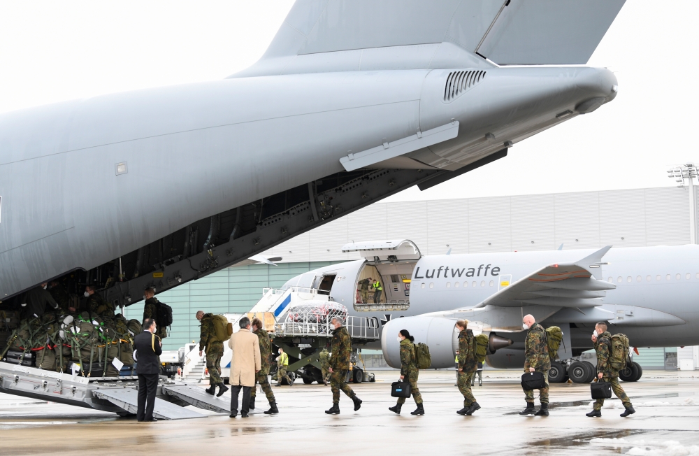 Staff members enter aboard an A400M military transport plane to COVID-19 stricken Portugal in Wunstorf, Germany, February 3, 2021. REUTERS/Fabian Bimmer
