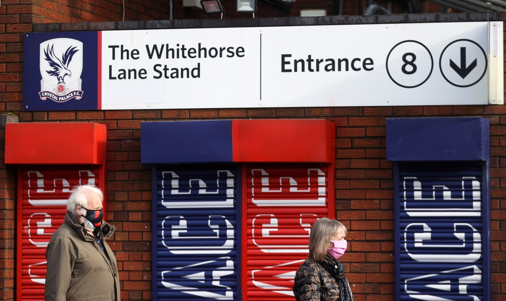People arrive to receive the COVID-19 vaccine at Crystal Palace Football Club Vaccination Centre, amid the outbreak of the coronavirus disease (COVID-19) in London, Britain February 4, 2021. REUTERS/Hannah McKay
