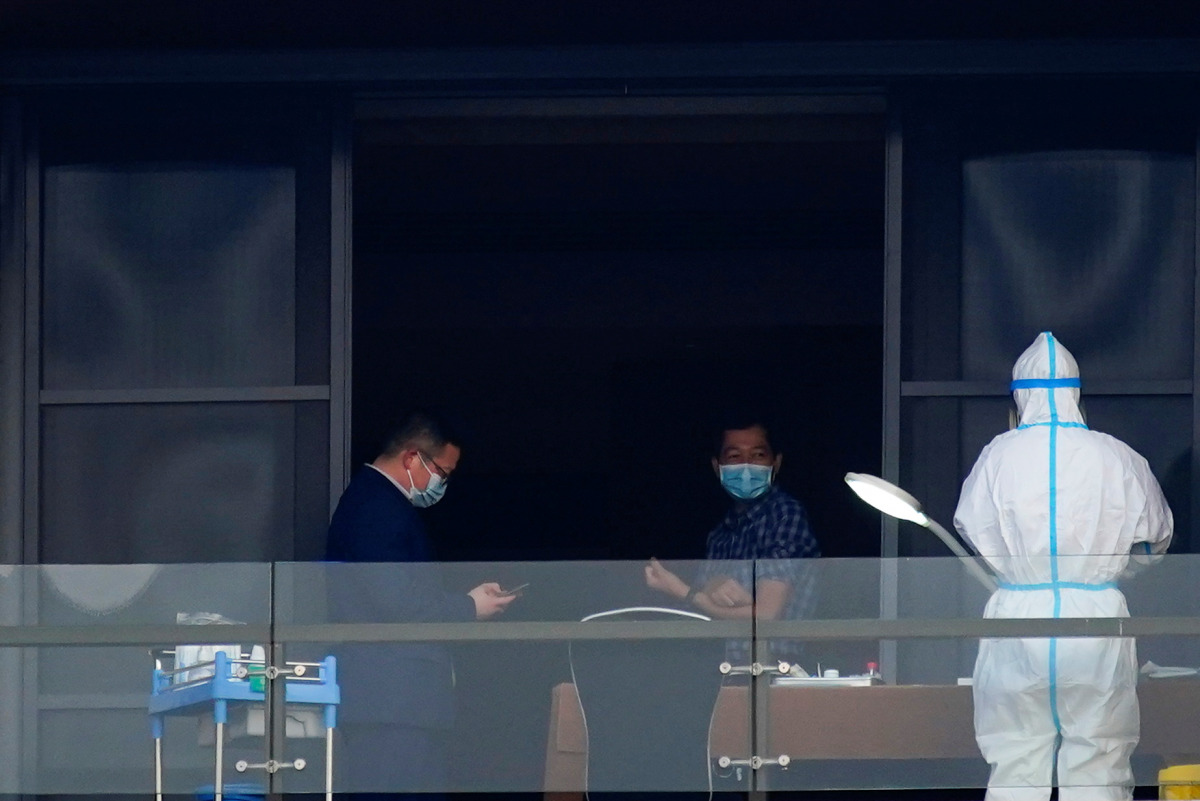 Hung Nguyen-Viet, a member of the World Health Organisation (WHO) team tasked with investigating the origins of the coronavirus disease (COVID-19), undergoes a blood test on the balcony of a hotel in Wuhan, Hubei province, China February 3, 2021. REUTERS/