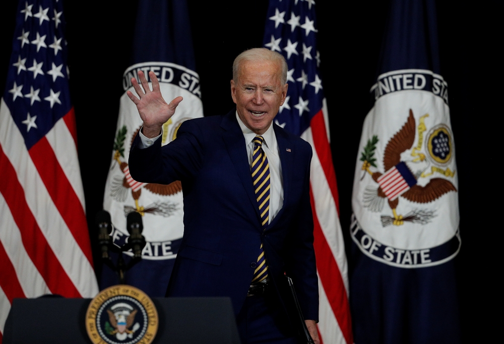 U.S. President Joe Biden waves after speaking to State Department staff during a visit by Biden at the State Department in Washington, U.S., February 4, 2021. REUTERS/Tom Brenner