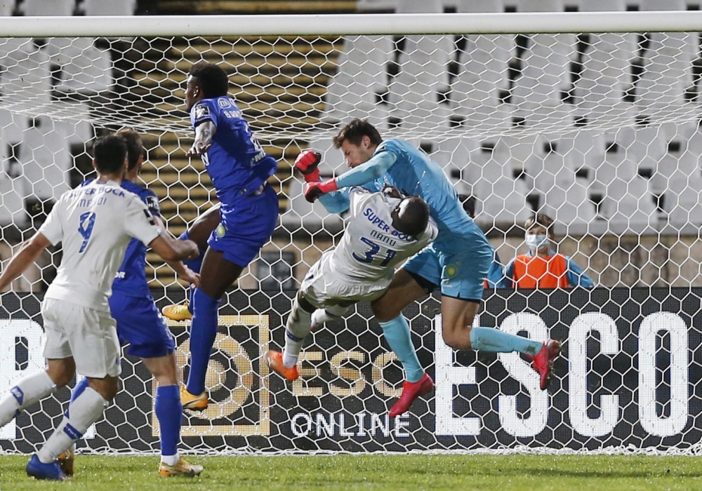 February 4, 2021 FC Porto's Nanu collides with Belenenses' Stanislav Kritsyuk REUTERS/Pedro Nunes