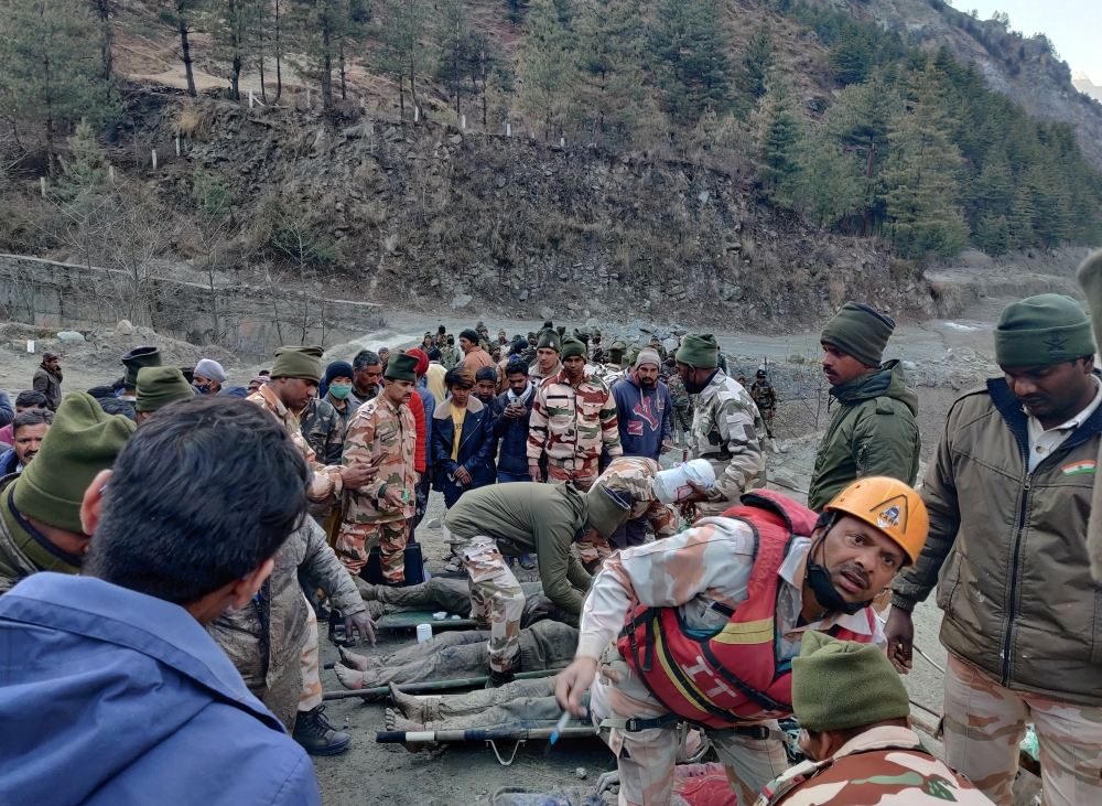 Members of Indo-Tibetan Border Police (ITBP) tend to people rescued after a Himalayan glacier broke and swept away a small hydroelectric dam, in Chormi village in Tapovan in the northern state of Uttarakhand, India, February 7, 2021. REUTERS/Stringer 