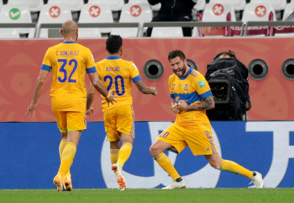 Tigres UANL's Andre Pierre Gignac celebrates scoring their first goal with Javier Aquino and Carlos Gonzalez REUTERS/Mohammed Dabbous
