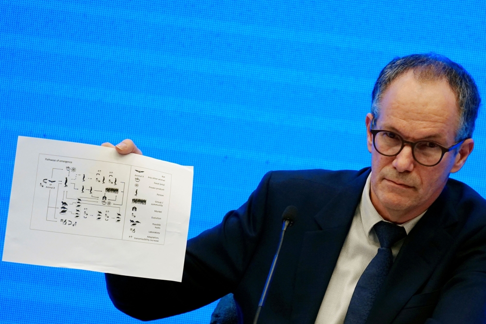 Peter Ben Embarek, a member of the World Health Organization (WHO) team tasked with investigating the origins of the coronavirus disease (COVID-19), holds a chart during the WHO-China joint study news conference at a hotel in Wuhan, Hubei province, China 