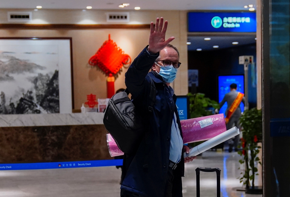 Peter Ben Embarek, a member of the World Health Organisation (WHO) team tasked with investigating the origins of the coronavirus disease (COVID-19), waves as he arrives at the airport to leave Wuhan, Hubei province, China February 10, 2021. REUTERS/Aly So